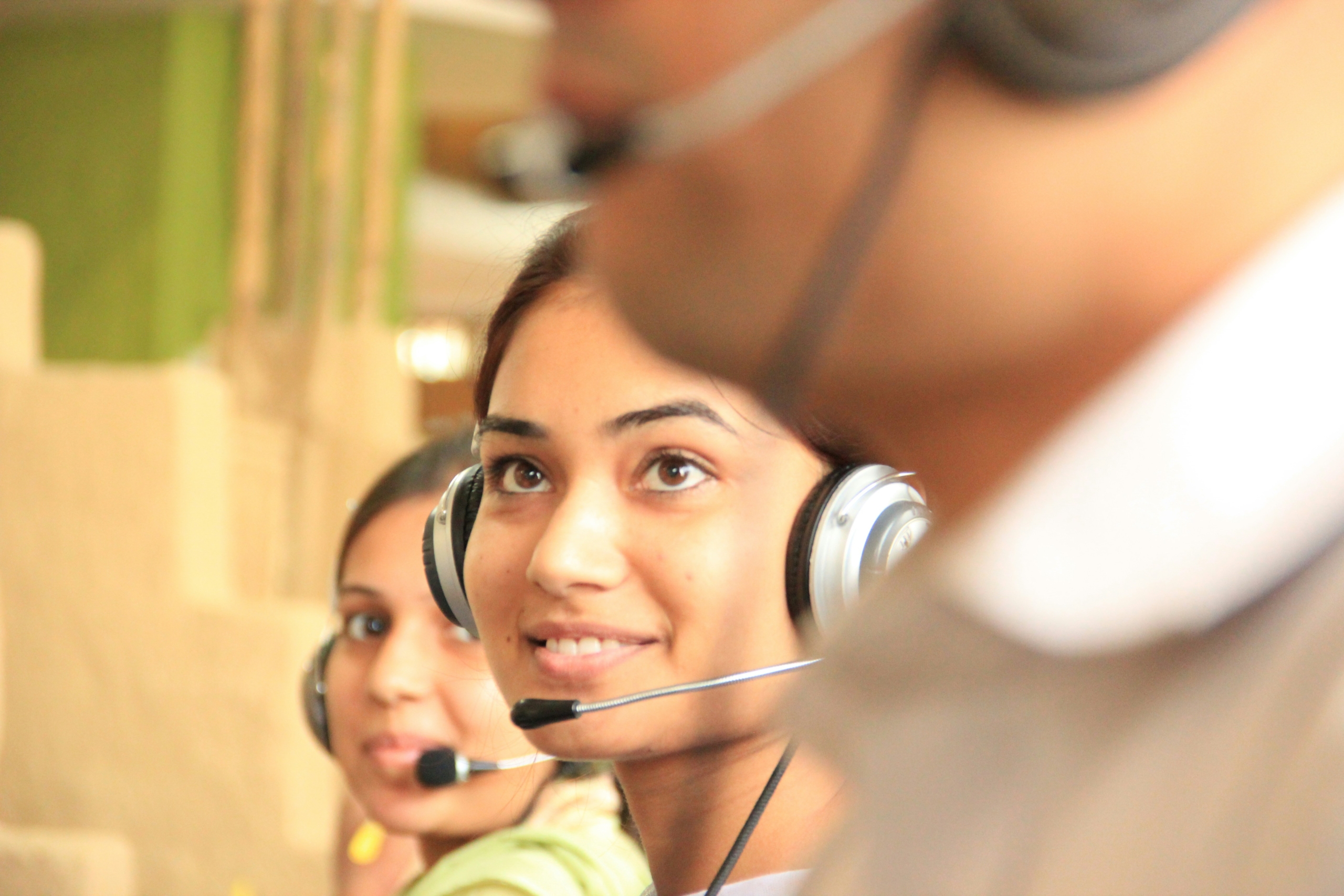 Call centre employees with a subtle smile on their faces.